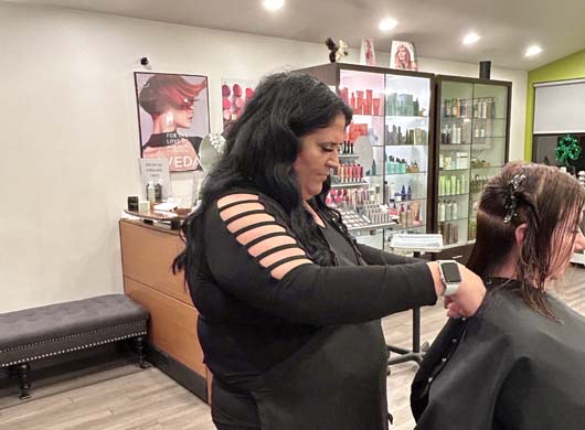 Julie giving client haircut