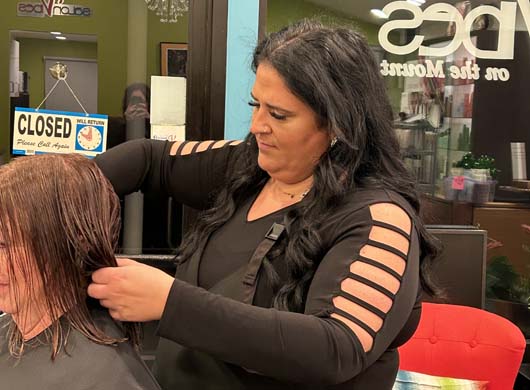 Julie giving client haircut